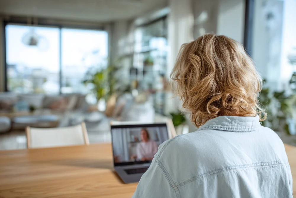A learner in a video session with a volunteer